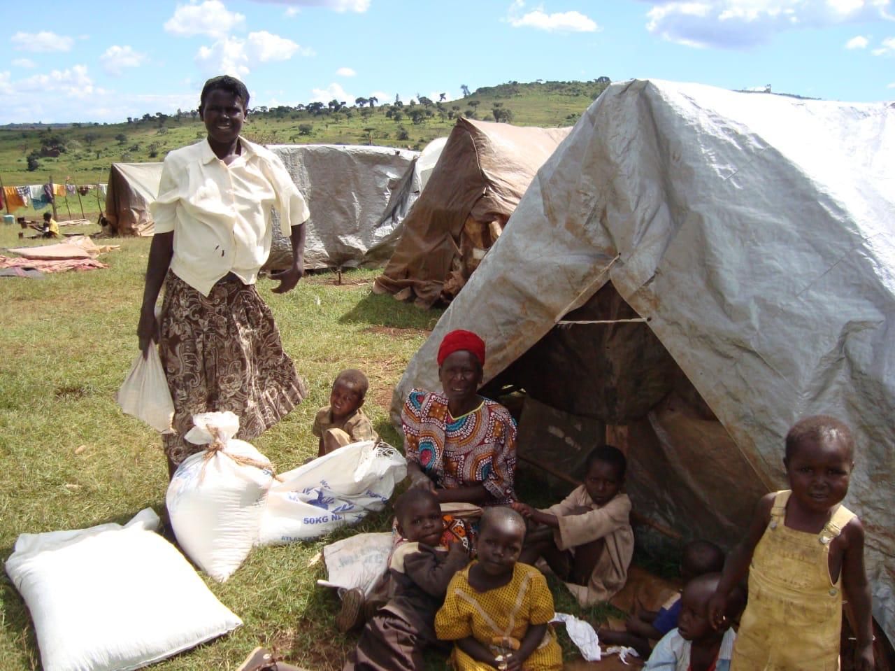 Families near tents with essential supplies